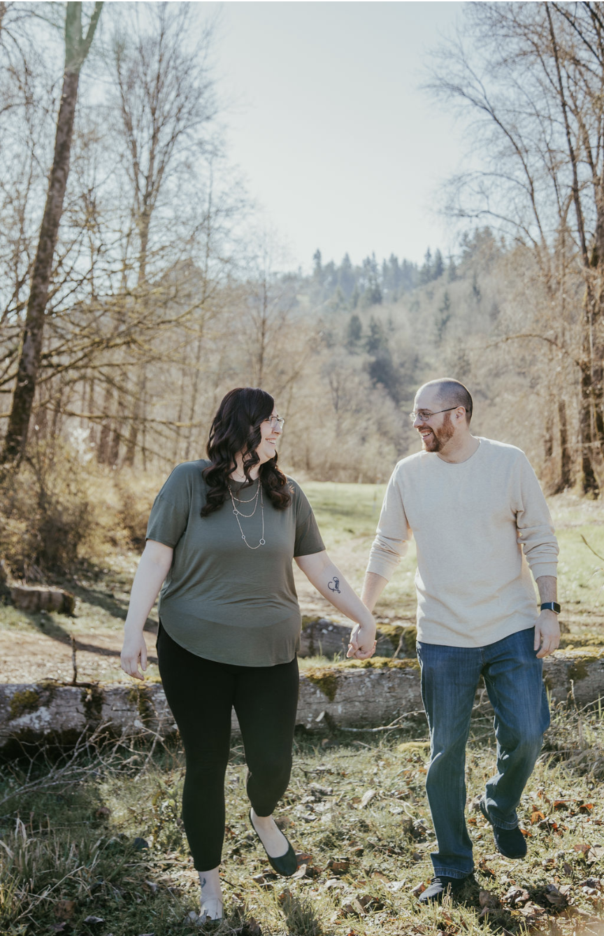 Keshia and Ben walking through a meadow on their engagement photoshoot